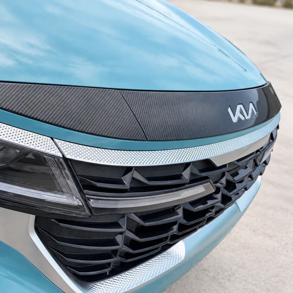 Real carbon fiber hood protector on a teal SUV
